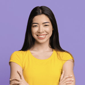 woman wearing a vibrant yellow shirt smiling in the camera