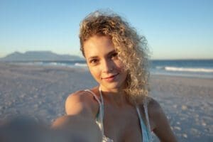 Portrait of beautiful woman standing on the beach